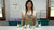 Instructor behind clay Santa figures in colorful outfits and snow-tipped green Christmas trees on white bases.