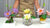 Purple, pale yellow, and pink clay water lilies with buds and green leaves arranged in three decorative containers.